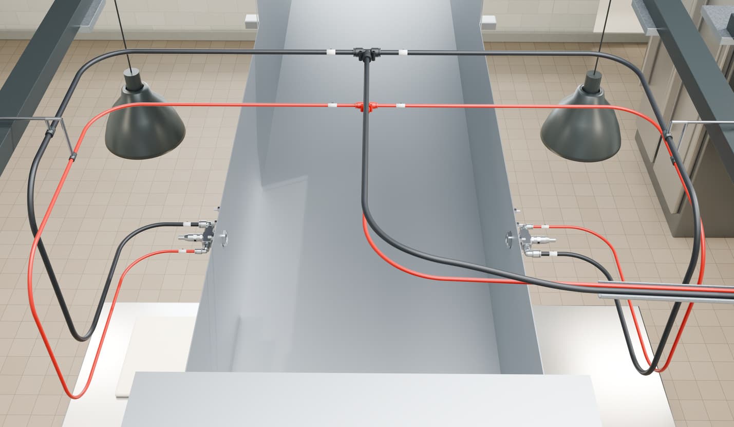 Brochure illustration of an exhaust duct from above, with air and solution lines teeing to two opposed nozzles.