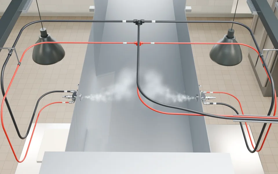 Brochure illustration of an exhaust duct from above: air and solution lines tee to two opposed nozzles, which mist into the duct.